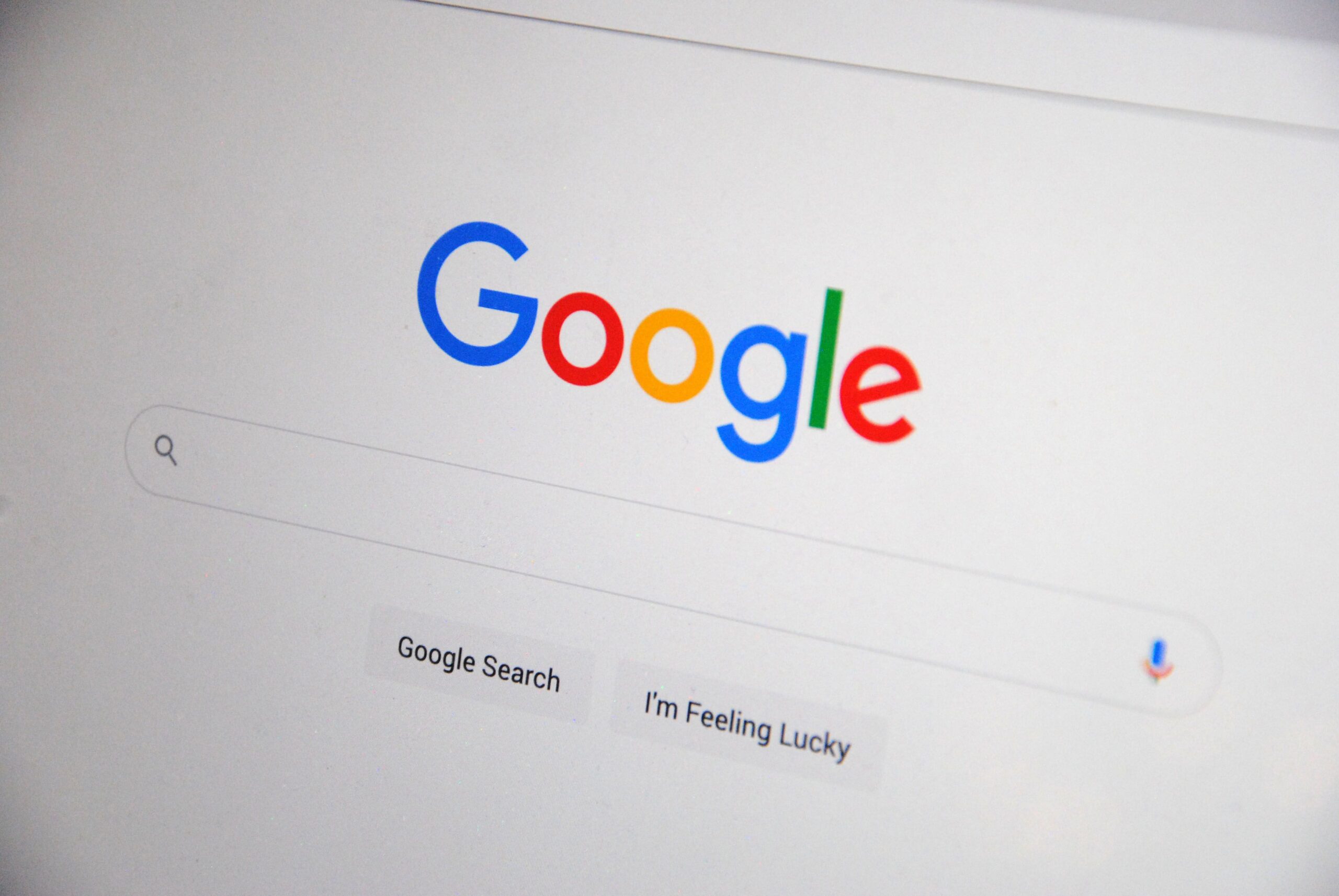 pexels-photo-13628541-13628541 Close-up of the Google homepage on a screen showing search options.